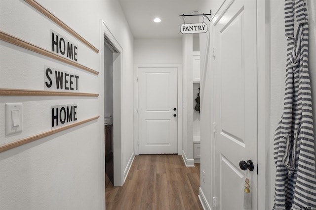 hall with wood-type flooring