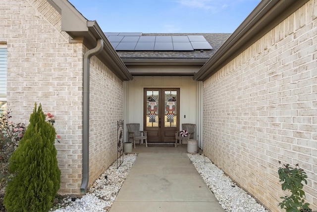 property entrance featuring solar panels and french doors