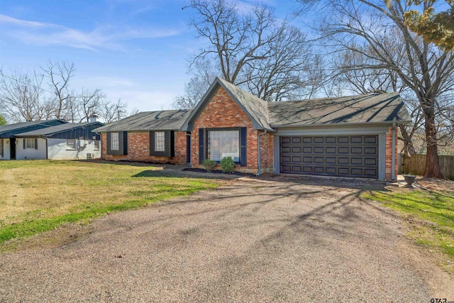 view of front of home featuring a garage, brick siding, fence, driveway, and a front yard