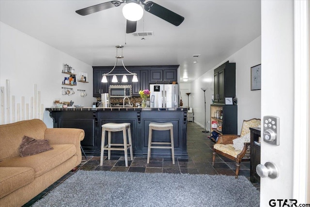 interior space with ceiling fan and sink