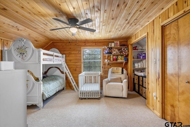 bedroom featuring carpet floors, wooden walls, and wooden ceiling