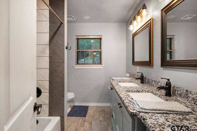 800 Neches Dr, Tyler, TX 75702 - full bath featuring double vanity, wood finished floors, and bathing tub / shower combination