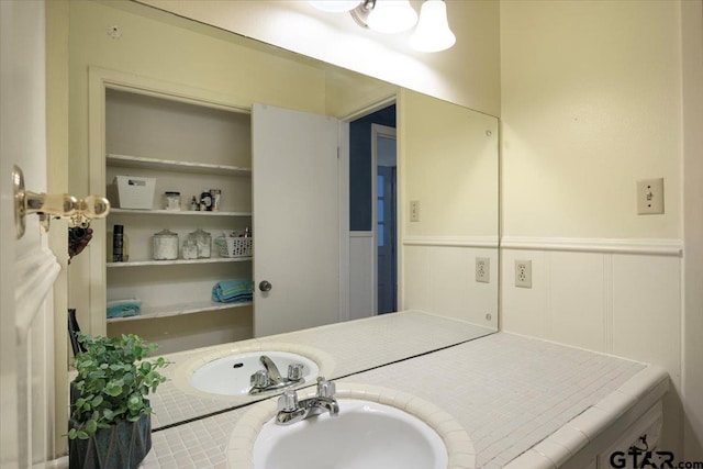 800 Neches Dr, Tyler, TX 75702 - bathroom with a wainscoted wall, vanity, and a decorative wall