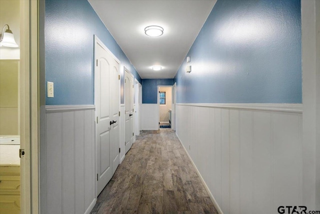 800 Neches Dr, Tyler, TX 75702 - hallway with wood finished floors and a wainscoted wall