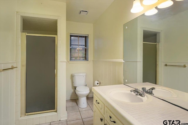 800 Neches Dr, Tyler, TX 75702 - bathroom with vanity, a stall shower, wainscoting, and tile patterned floors