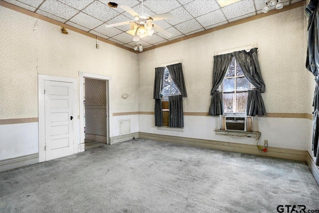 carpeted empty room featuring a paneled ceiling, cooling unit, and ceiling fan