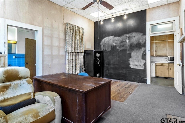 office with track lighting, ceiling fan, and a paneled ceiling