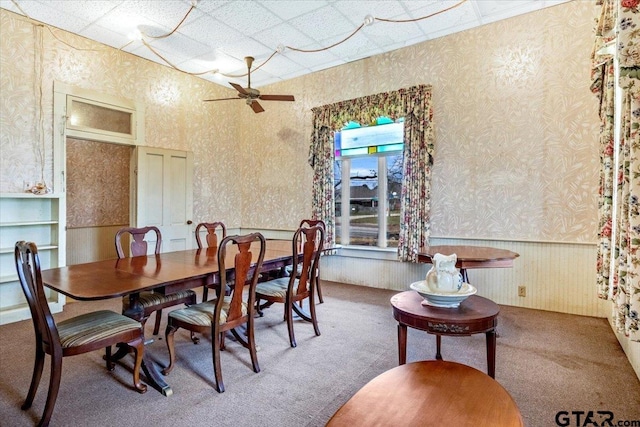 dining area with ceiling fan and carpet