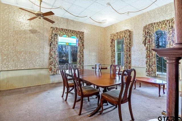 carpeted dining room with ceiling fan