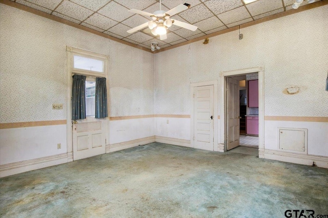 carpeted spare room featuring ceiling fan