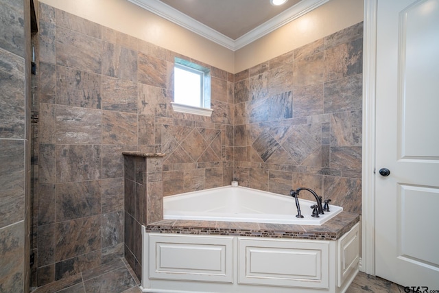 bathroom with crown molding and a tub