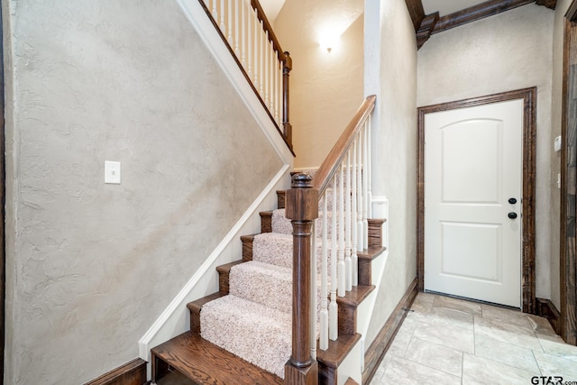 stairs featuring a high ceiling