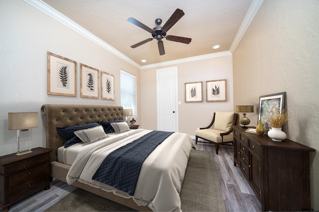 bedroom with ceiling fan, hardwood / wood-style floors, and ornamental molding