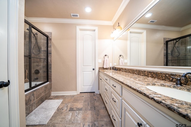 bathroom with shower / bath combination with glass door, vanity, and ornamental molding