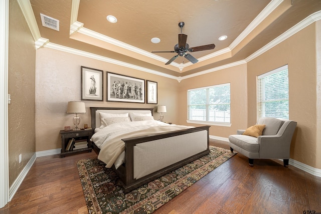 bedroom with a raised ceiling, ceiling fan, crown molding, and dark hardwood / wood-style floors