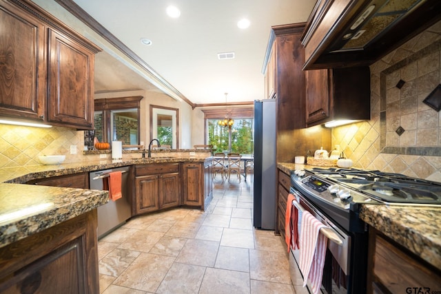 kitchen featuring sink, a notable chandelier, appliances with stainless steel finishes, custom range hood, and ornamental molding