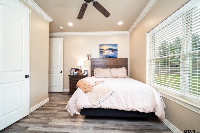 bedroom with ceiling fan, hardwood / wood-style flooring, and ornamental molding