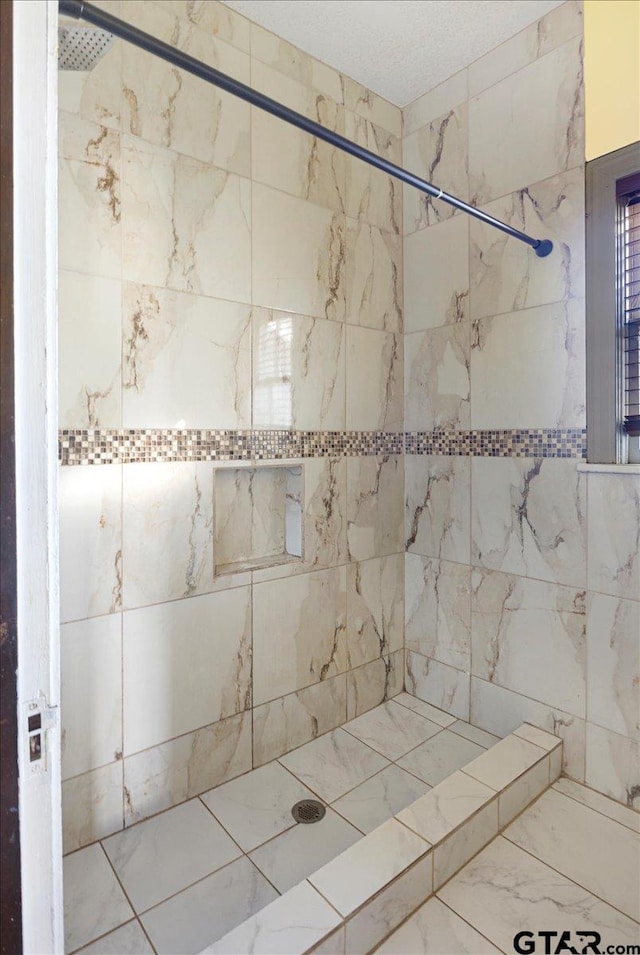 bathroom with a tile shower