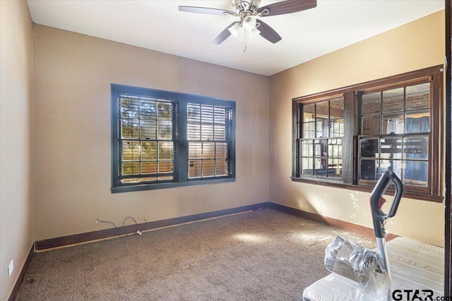 carpeted spare room with ceiling fan