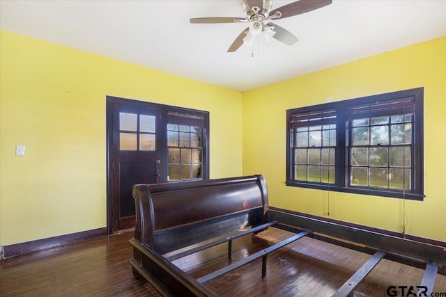 bedroom with dark wood-type flooring and ceiling fan