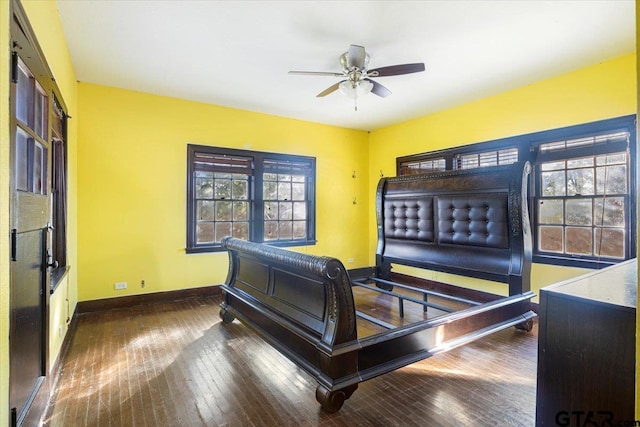 interior space featuring dark wood-type flooring and ceiling fan