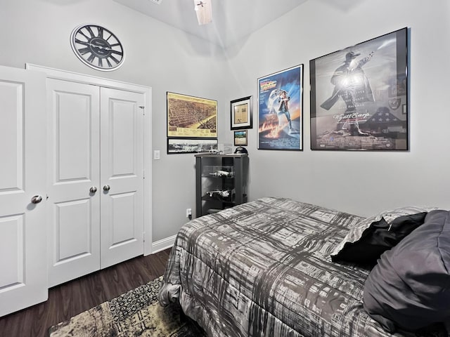 bedroom featuring dark hardwood / wood-style floors and a closet