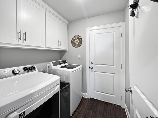 clothes washing area with separate washer and dryer, dark wood finished floors, cabinet space, and baseboards