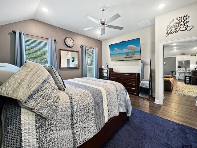 bedroom featuring stainless steel refrigerator with ice dispenser, ceiling fan, vaulted ceiling, and hardwood / wood-style flooring