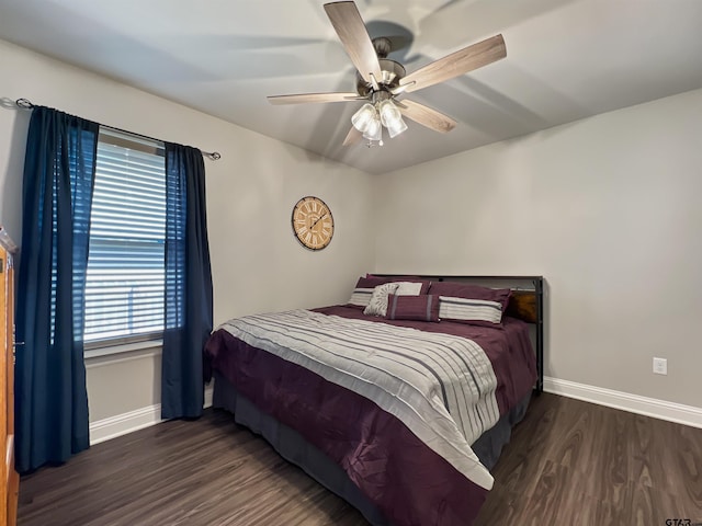 bedroom featuring ceiling fan, baseboards, and wood finished floors