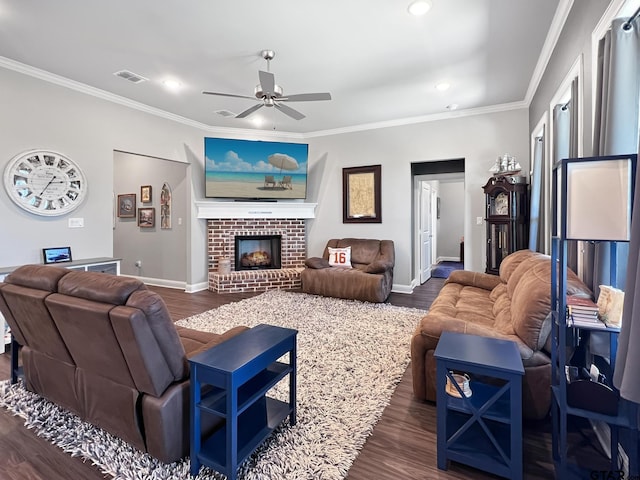 living room featuring ornamental molding, a fireplace, and dark hardwood / wood-style flooring