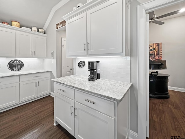 kitchen featuring white cabinetry, dark hardwood / wood-style flooring, and light stone countertops