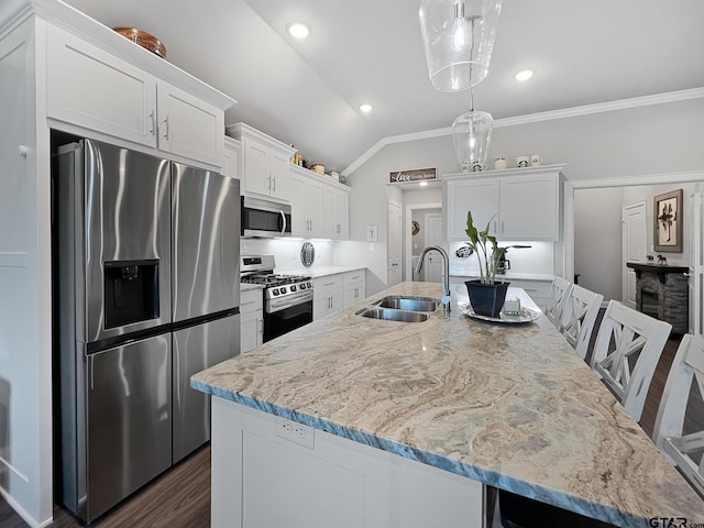 kitchen with sink, a center island with sink, white cabinets, and appliances with stainless steel finishes