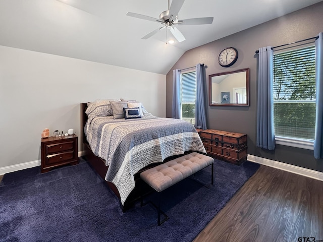 bedroom featuring multiple windows, vaulted ceiling, dark hardwood / wood-style floors, and ceiling fan