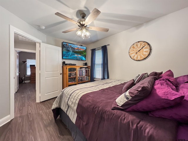 bedroom featuring baseboards, a ceiling fan, and wood finished floors