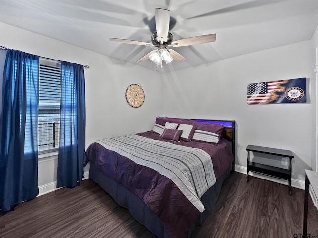 bedroom with dark hardwood / wood-style floors and ceiling fan