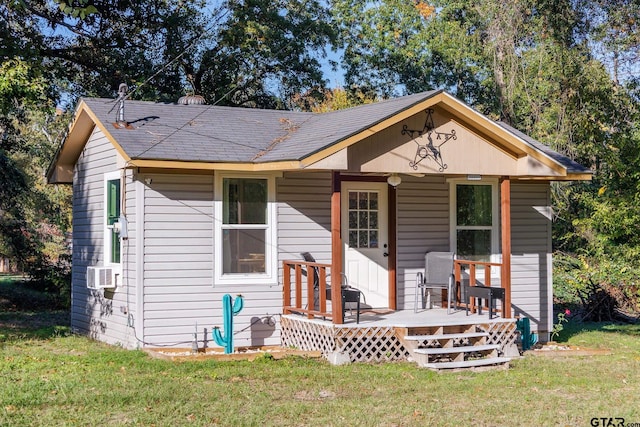 view of front of house with cooling unit and a front lawn