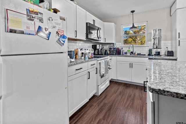 kitchen featuring white cabinetry, sink, decorative light fixtures, and white appliances