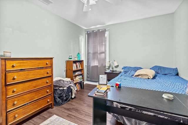 bedroom with dark hardwood / wood-style floors and ceiling fan