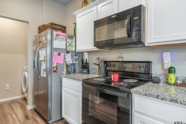 109 Summit Cv, Jacksonville, TX 75766 - kitchen featuring black appliances, light wood-style floors, and white cabinets