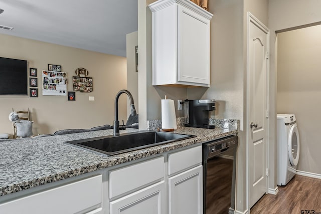 109 Summit Cv, Jacksonville, TX 75766 - kitchen with washer / clothes dryer, dishwasher, a sink, wood finished floors, and white cabinetry