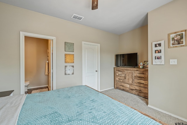 109 Summit Cv, Jacksonville, TX 75766 - carpeted bedroom with baseboards, ensuite bath, and ceiling fan