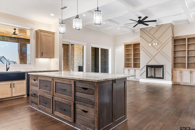 kitchen with beam ceiling, pendant lighting, coffered ceiling, a center island, and dark hardwood / wood-style floors