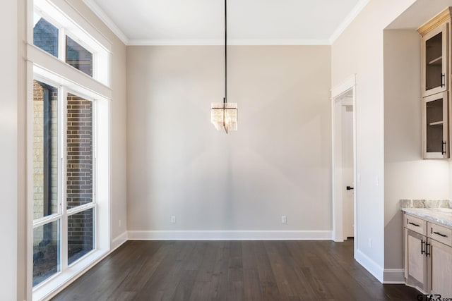 unfurnished dining area with crown molding and dark hardwood / wood-style flooring