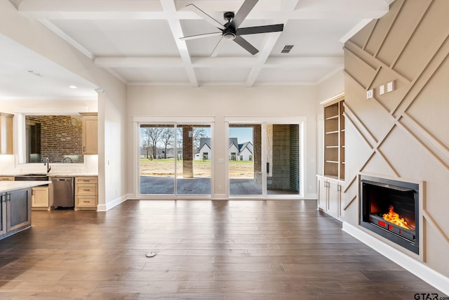 unfurnished living room featuring coffered ceiling, sink, beamed ceiling, dark hardwood / wood-style floors, and ceiling fan