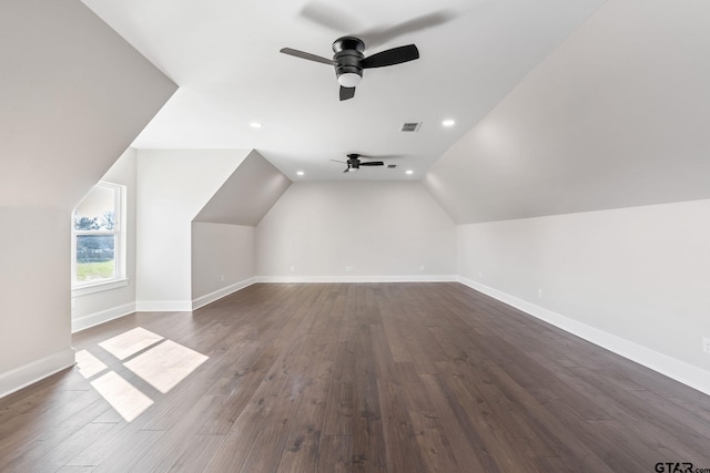 bonus room with ceiling fan, dark wood-type flooring, and vaulted ceiling