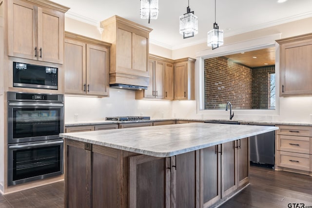 kitchen with appliances with stainless steel finishes, decorative light fixtures, light stone countertops, and ornamental molding