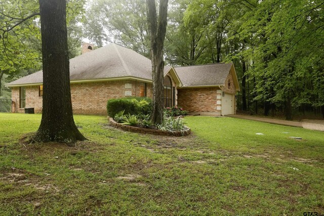 414 Winding Ln, Mount Vernon, TX 75457 - view of property exterior with brick siding, an attached garage, a yard, and a chimney