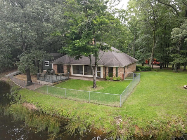 414 Winding Ln, Mount Vernon, TX 75457 - rear view of house featuring a fenced backyard, brick siding, a shingled roof, and a wooden deck