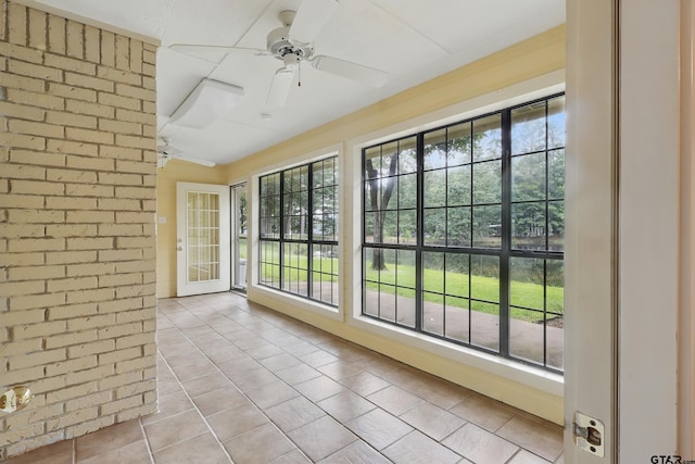 414 Winding Ln, Mount Vernon, TX 75457 - unfurnished sunroom featuring tile patterned flooring and brick wall