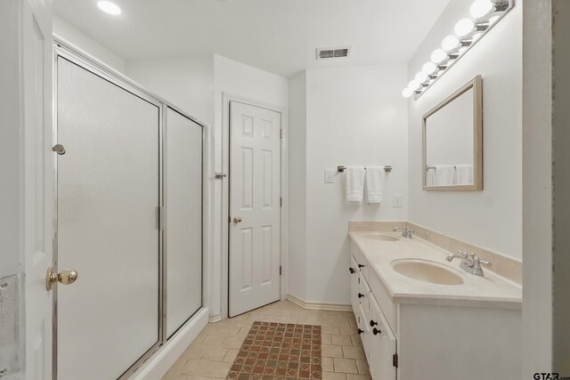 414 Winding Ln, Mount Vernon, TX 75457 - bathroom featuring double vanity, a shower stall, and tile patterned flooring